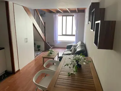 a living room with a table and a couch at SAELUMA Suite Apart in Lima