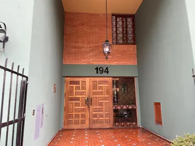a front door of a building with a sign on it at SAELUMA Suite Apart in Lima