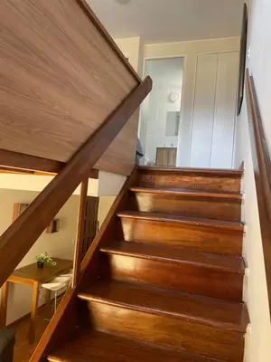 a staircase with wooden treads in a house at SAELUMA Suite Apart in Lima
