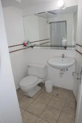 a bathroom with a toilet and a sink at Casita de Miraflores calle Ocharan a 5 minutos de Larcomar in Lima