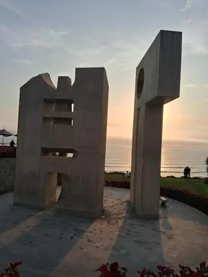 a sculpture of a largeolith in front of the ocean at Casita de Miraflores calle Ocharan a 5 minutos de Larcomar in Lima