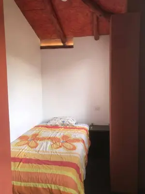 a bedroom with a bed in a room at Casa de Marguito in Urubamba