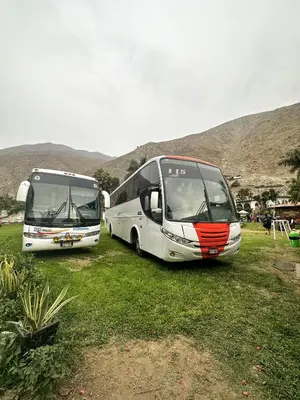 two buses parked next to each other in a field at QPÑ Hoteles - Hacienda Nieve Nieve in Balconcillo de Aviyay