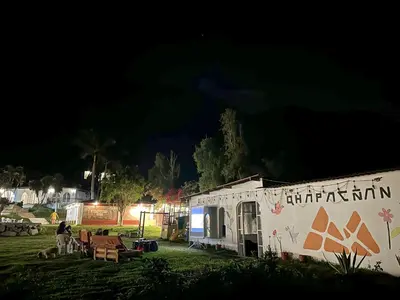 a building with graffiti on the side of it at night at QPÑ Hoteles - Hacienda Nieve Nieve in Balconcillo de Aviyay