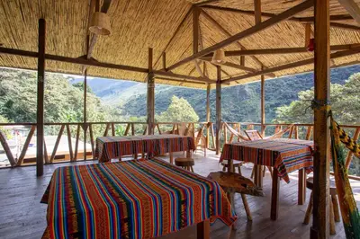 a room with two tables and a view of the mountains at Viamonte EcoLodge in Santa Teresa