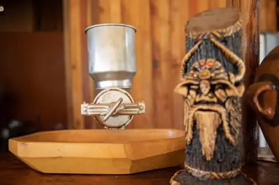 a small figurine sitting on a table next to a clock at Viamonte EcoLodge in Santa Teresa
