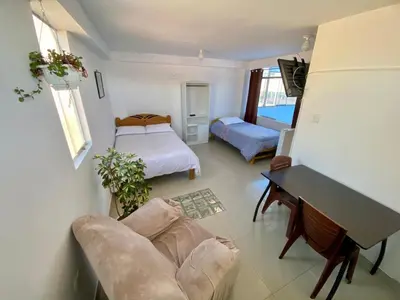 a living room with a bed and a couch at Marlen's Qorywasi in Cusco