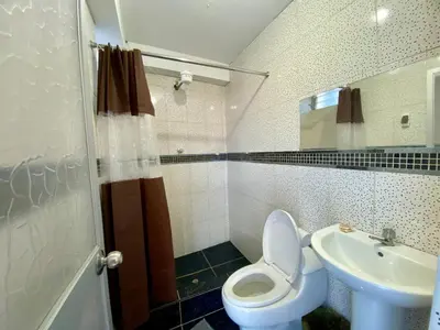 a bathroom with a toilet and a sink at Marlen's Qorywasi in Cusco