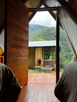 a view from the inside of a house with mountains in the background at ALPHINA CABINS Qhapaq Ñan in Sahuayacu
