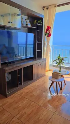 a living room with a large flat screen tv at An apartment with an ocean view, near the airport in Lima