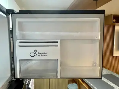 an empty refrigerator with its door open in a kitchen at Céntrico departamento in Lima