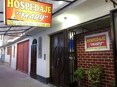 a building with a sign for a hospected market markup at Hospedaje MARY in Quinua