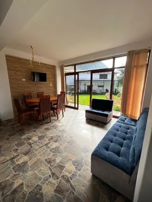 a living room with a blue couch and a table at Lofts Illawasi in Urubamba