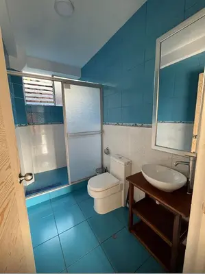 a blue bathroom with a toilet and a sink at Lofts Illawasi in Urubamba