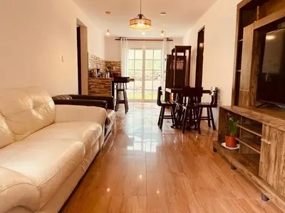 a living room with a couch and a table at Sweet Home Oxapampa in Oxapampa