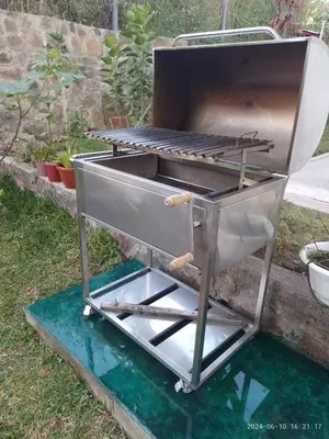 a barbecue grill sitting on the grass in a yard at Sweet Home Oxapampa in Oxapampa