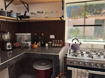a kitchen with a stove and a counter top at Casa Muyuna in Calca