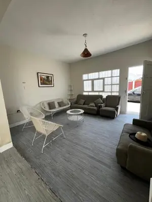 a living room with a couch and a table at Casa playa Punta Hermosa in Punta Hermosa