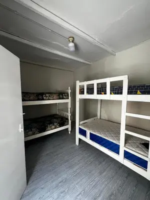 two white bunk beds in a room at Casa playa Punta Hermosa in Punta Hermosa