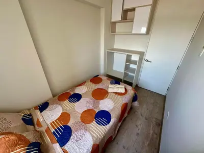 a small bedroom with a bed in a room at Departamento con vistas al mar - Costa Lounge in Lima