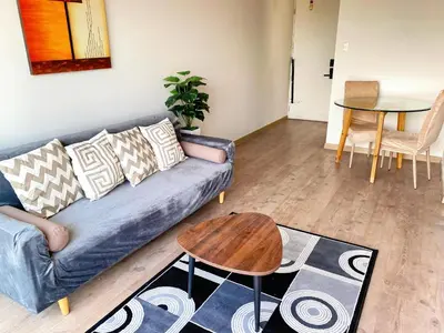 a living room with a couch and a table at Departamento con vistas al mar - Costa Lounge in Lima