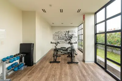 a fitness room with a gym with exercise equipment at Sunline 2BR by Geko in Lima