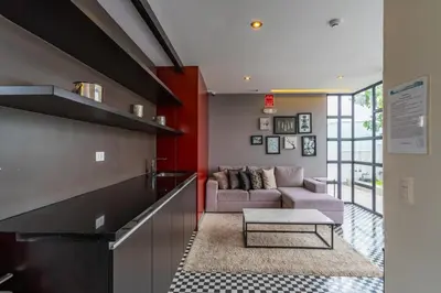 a living room with a couch and a table at Sunline 2BR by Geko in Lima