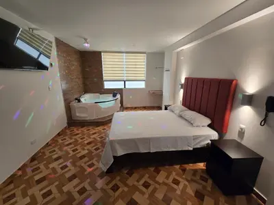 a bedroom with a bed and a tub and a sink at Hostal Prestigio in Lima