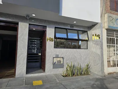 a facade of a building with a door and windows at Hostal Prestigio in Lima