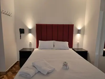 a bedroom with a large bed with two towels on it at Hostal Prestigio in Lima