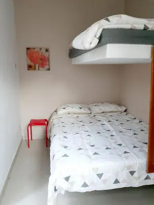 a bedroom with a bed and a bunk bed at Villa Lunahuana in Lunahuaná