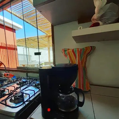 a kitchen with a blender on a counter next to a stove at Villa Lunahuana in Lunahuaná