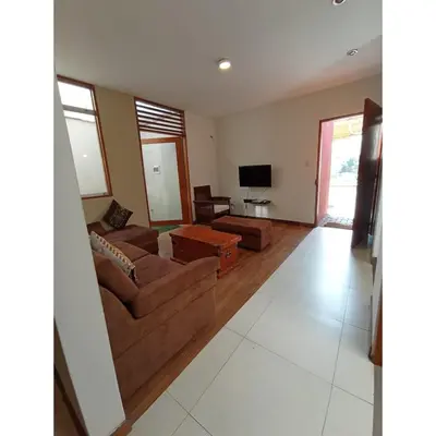 a living room with two couches and a tv at Villa Lunahuana in Lunahuaná