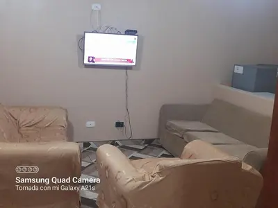 a living room with two couches and a flat screen tv at Your home in the city awaits in Lima