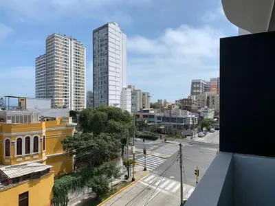 a view of a city street with tall buildings at Departamento céntrico rodeado de áreas verdes in Lima