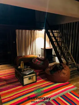 a living room with a couch and a rug at Sumaqay Lodge -Naturaleza Arte y Arquitectura