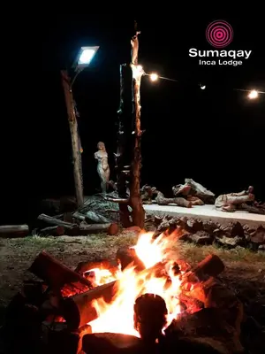 a fire pit in a yard at night at Sumaqay Lodge -Naturaleza Arte y Arquitectura