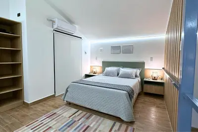 a bedroom with a bed and two night stands at Tiny House con Piscina Privada, AC and Starlink in Paracas