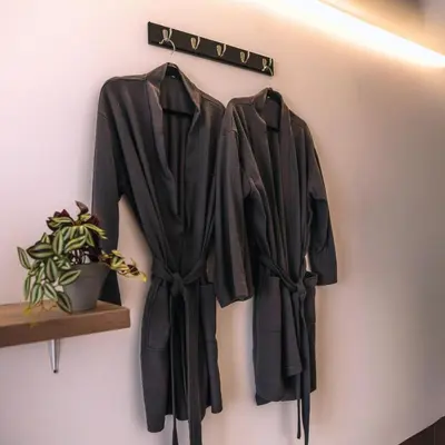 a black robe hanging on a wall at Tiny House con Piscina Privada, AC and Starlink in Paracas