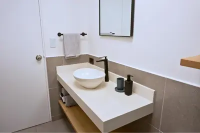 a bathroom with a white sink and a mirror at Tiny House con Piscina Privada, Jacuzzi, Parrilla y Starlink in Punta Negra