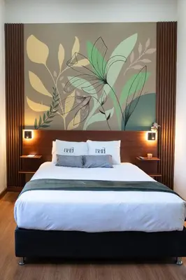 a bedroom with a large bed with a painting on the wall at Bosco Hotel Boutique in Cusco