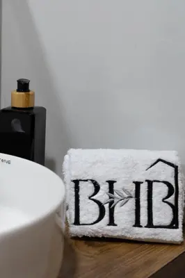 a white towel with the word bltec on a table at Bosco Hotel Boutique in Cusco