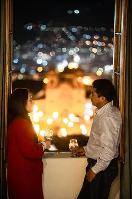 a man and a woman standing next to a counter with drinks at Bosco Hotel Boutique in Cusco