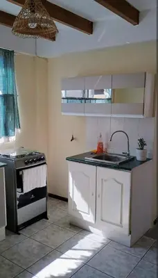 a kitchen with a sink and a stove at centrico departamento in Cusco
