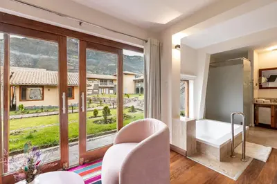 a living room with a view of a house at Casa Eva Hotel Boutique in Urubamba
