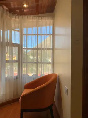 a chair sitting in front of a window at Juliet's House in Ollantaytambo