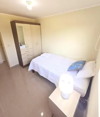 a bedroom with a bed and a table and a mirror at Apartamento Premium frente a Universidad San Marcos para 4 pers en lima in Lima