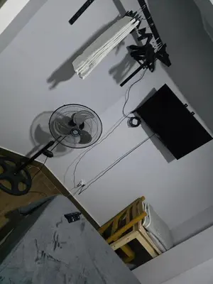 a white room with a fan on the ceiling at Aero- apartamento in Lima