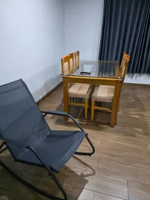 a glass table and a chair and a glass table and chairs at Aero- apartamento in Lima