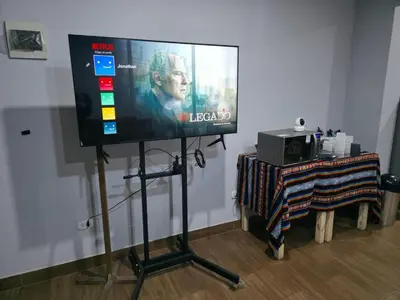a flat screen tv on a stand with a video game at Aero- apartamento in Lima